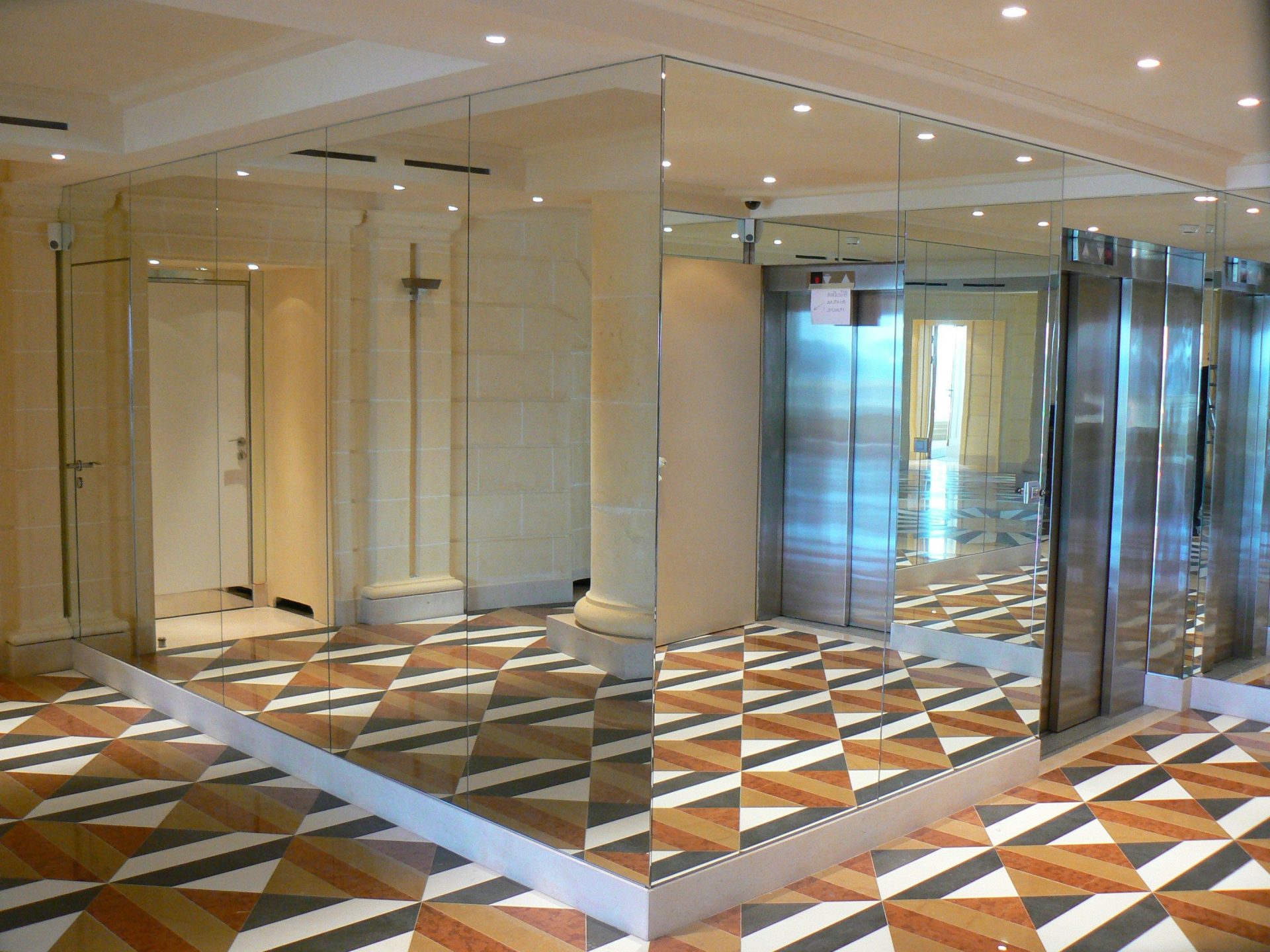 A large room with a checkered floor and mirrored walls